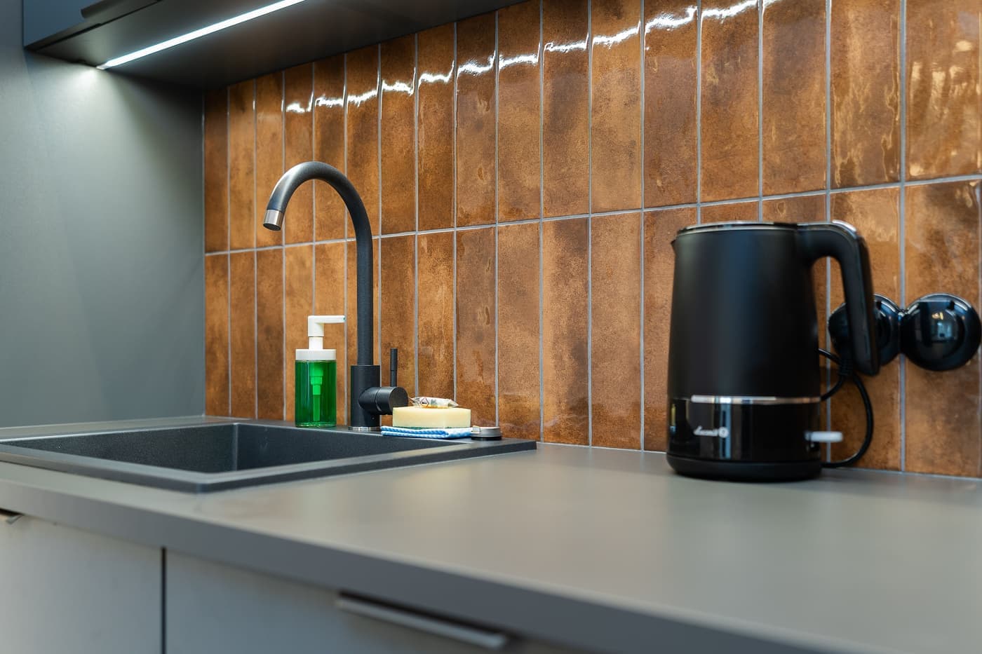 Modern kitchen counter with a trash can beside the cabinets