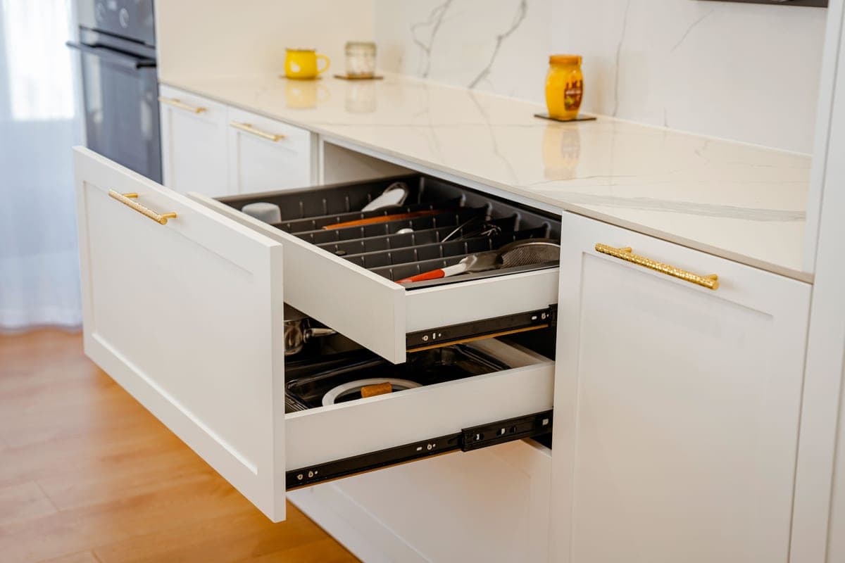 Open kitchen cabinet with a pull-out drawer